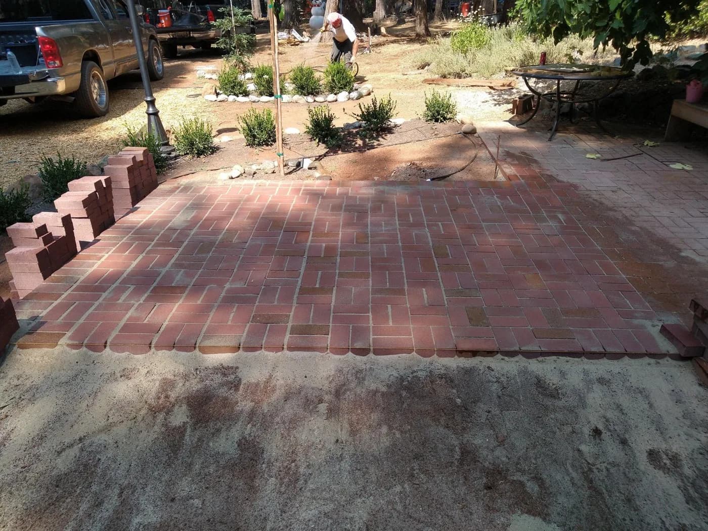 Finished brick patio laid in a running bond pattern beside a raised planter