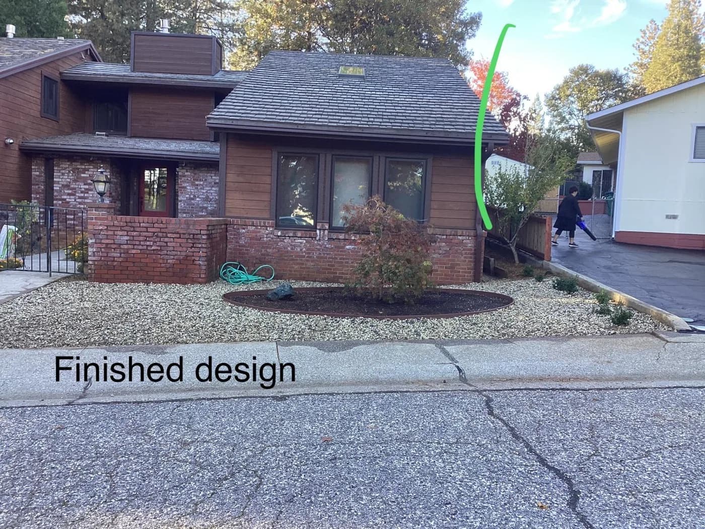 Finished low-water front yard design with gravel ground cover and young shrubs